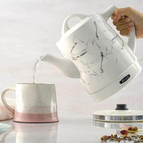 bouilloire électrique versant de l'eau chaude dans une tasse