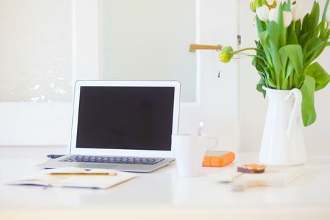 Travail à domicile. Ordinateur portable sur un bureau dans un salon ou une cuisine moderne. Bureau à domicile